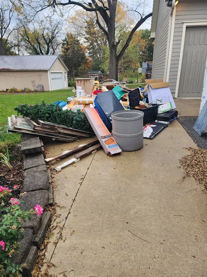 Dumpster being loaded with debris for 12 Yard Dumpster Rental in Eveleth